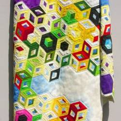 Close up view of The Theory of Everything Quilt Wood Carving by Fraser Smith