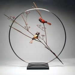 A metal sculpture of a pair of Cardinals by Don Rambadt A metal sculpture of a pair of Cardinals by Don Rambadt