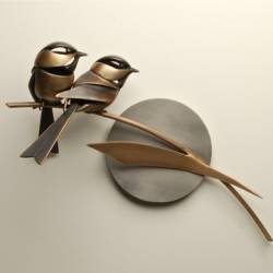 A metal sculpture of a pair of Chickadees by Don Rambadt